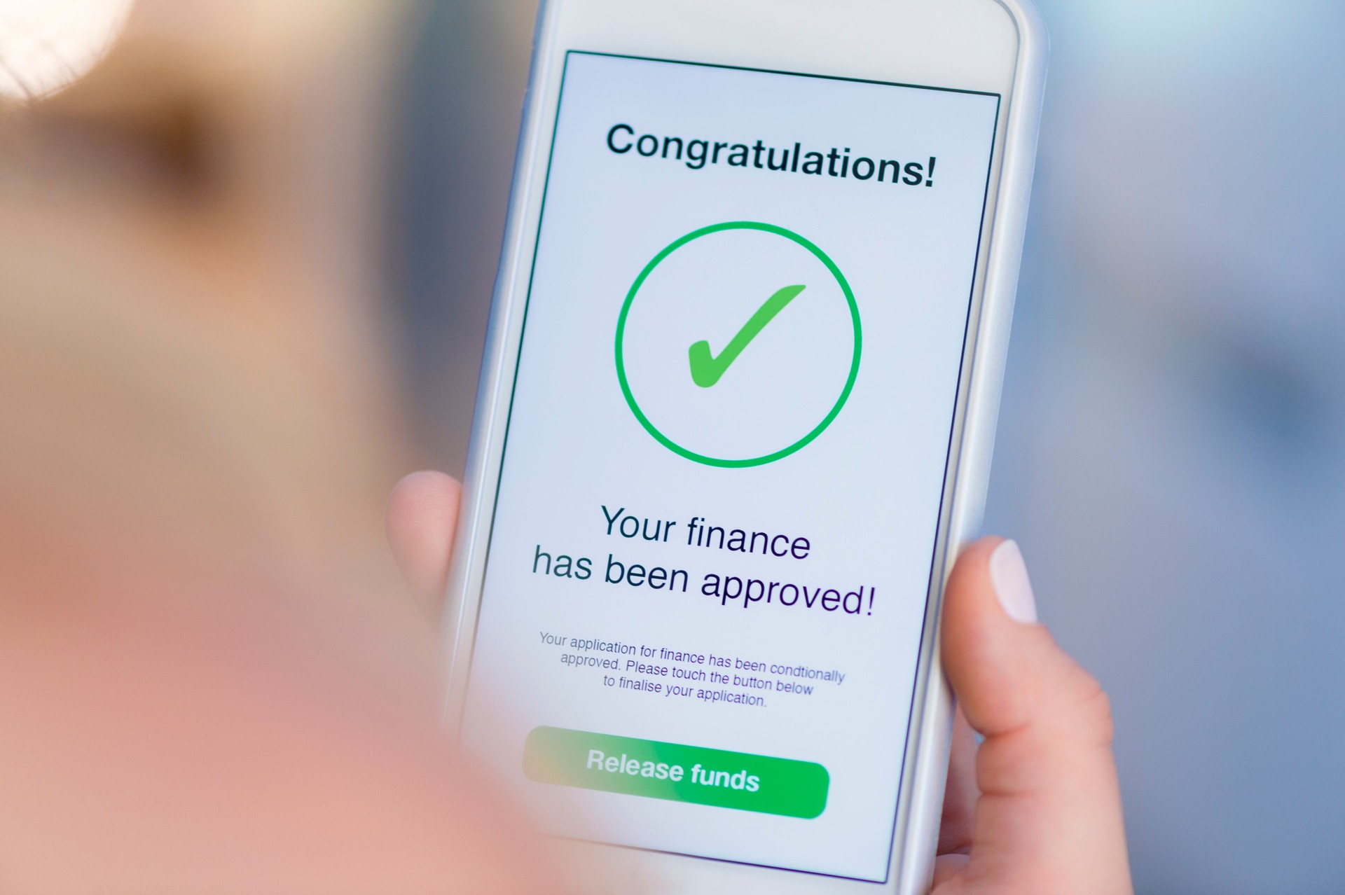 Mortgage Loan approval on mobile phone in a house.